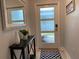 Stylish entryway features a decorative mirror, table with vases, and an ornate rug at 637 Ocean Course Ave, Davenport, FL 33896
