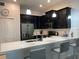 Modern kitchen featuring stainless appliances, a breakfast bar with seating and pendant lighting at 637 Ocean Course Ave, Davenport, FL 33896
