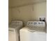 Convenient laundry area with both washer and dryer, plus shelving above at 637 Ocean Course Ave, Davenport, FL 33896