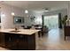Open floor plan combining kitchen, dining, and living areas with sliding glass doors to the patio at 637 Ocean Course Ave, Davenport, FL 33896