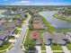 Aerial view of home in a lakeside community with lush landscaping and serene water views at 639 Chadbury Way, Kissimmee, FL 34744