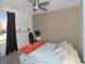 Comfortable bedroom with ceiling fan, window with blinds, and spacious closet at 639 Chadbury Way, Kissimmee, FL 34744
