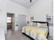 Bright bedroom showcasing wood-look floors, neutral walls, a comfortable bed, closet and an ensuite bathroom at 639 Chadbury Way, Kissimmee, FL 34744