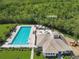 Aerial view of community clubhouse featuring a swimming pool, sundeck, and playground at 639 Chadbury Way, Kissimmee, FL 34744