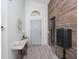 Inviting entryway with wood-look flooring, stylish console table, and decorative wall mirror at 639 Chadbury Way, Kissimmee, FL 34744