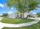 Charming single-story home with lush green lawn and mature shade tree in a well-manicured yard at 639 Chadbury Way, Kissimmee, FL 34744