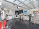 Spacious garage with epoxy floor, laundry area, sink, TV, and ample storage space at 639 Chadbury Way, Kissimmee, FL 34744