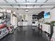 Spacious garage with epoxy floor, laundry area, sink, TV, and ample storage space at 639 Chadbury Way, Kissimmee, FL 34744