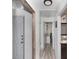 Hallway view showcases wood-look flooring and transitions to the bathroom and bedroom at 639 Chadbury Way, Kissimmee, FL 34744