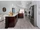 Kitchen has an island with lots of counter space and wood-look floors at 639 Chadbury Way, Kissimmee, FL 34744