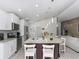 Open kitchen features island with pendant lighting and bar seating at 639 Chadbury Way, Kissimmee, FL 34744