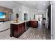 Open floor plan kitchen with island and wood cabinets and stainless appliances at 639 Chadbury Way, Kissimmee, FL 34744