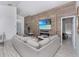 Stylish living room featuring a wood-paneled accent wall with a fireplace and large television at 639 Chadbury Way, Kissimmee, FL 34744