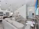 Spacious open-concept living area with modern furnishings and view of the kitchen at 639 Chadbury Way, Kissimmee, FL 34744