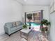 Open living room with sliding glass door access to screened-in pool at 639 Chadbury Way, Kissimmee, FL 34744