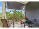 Relaxing balcony features patio seating, a rocking chair, and scenic green views at 650 Campus St # 309, Celebration, FL 34747