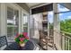Cozy balcony with outdoor seating and a view of neighboring buildings and trees at 650 Campus St # 309, Celebration, FL 34747