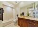 Bright bathroom featuring a shower-tub, toilet, and vanity with beige countertops at 650 Campus St # 309, Celebration, FL 34747