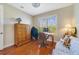 Bright bedroom with a desk, wood floors, ceiling fan and an inviting couch at 650 Campus St # 309, Celebration, FL 34747