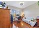 Bright bedroom with a desk, wood floors, ceiling fan and an inviting couch at 650 Campus St # 309, Celebration, FL 34747