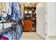 Walk-in closet with extensive built-in shelving and storage, with clothing and accessories at 650 Campus St # 309, Celebration, FL 34747