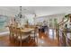 Open-concept living and dining area with hardwood floors and a chandelier at 650 Campus St # 309, Celebration, FL 34747