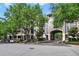 A large condo building with mature trees, and a covered parking area entrance at 650 Campus St # 309, Celebration, FL 34747