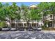 Exterior view of condo building with parking available and mature landscaping at 650 Campus St # 309, Celebration, FL 34747