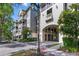 Beautiful condo building with a covered parking area entrance and mature landscaping at 650 Campus St # 309, Celebration, FL 34747