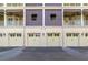 Townhome garages with updated doors and exterior lighting beneath private balconies at 650 Campus St # 309, Celebration, FL 34747