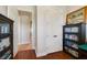 Hallway view with doors and decorative bookshelf, featuring wood floors at 650 Campus St # 309, Celebration, FL 34747