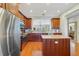 Well-appointed kitchen with wood cabinets, stainless steel appliances, and granite counters at 650 Campus St # 309, Celebration, FL 34747