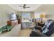 Comfortable bedroom featuring balcony access, ceiling fan, carpeted floors, and a sitting chair at 650 Campus St # 309, Celebration, FL 34747