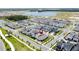 An aerial view showcasing the layout of a residential area, landscaping, and street network at 6514 Barnstorm Way, St Cloud, FL 34771