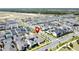 An aerial view pinpoints a home with solar panels in a well-planned community at 6514 Barnstorm Way, St Cloud, FL 34771