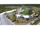 An aerial view of the 'Basecamp' recreational area featuring yurts, a playground, and parking at 6514 Barnstorm Way, St Cloud, FL 34771
