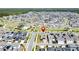 Wide aerial shot showcasing community layout, pool, and numerous houses at 6514 Barnstorm Way, St Cloud, FL 34771
