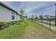 The spacious backyard features lush green grass, bordered by a sleek fence and well-manicured landscaping at 6514 Barnstorm Way, St Cloud, FL 34771