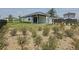 Well-maintained backyard with green grass and planted greenery around the back and a modern fence at 6514 Barnstorm Way, St Cloud, FL 34771