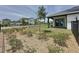 Well-maintained backyard with green grass and planted greenery around the back and a modern fence at 6514 Barnstorm Way, St Cloud, FL 34771