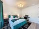 Well-lit bedroom with dark green curtains, teal accents, white walls, desk and black and white rug at 6514 Barnstorm Way, St Cloud, FL 34771