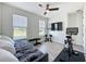Bedroom featuring workout equipment, laminate floors, a ceiling fan and natural light from two windows at 6514 Barnstorm Way, St Cloud, FL 34771