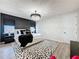 Modern bedroom features a stylish chandelier, accent wall, patterned rug, and contemporary decor at 6514 Barnstorm Way, St Cloud, FL 34771