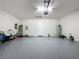 Large two-car garage featuring epoxy flooring, an automatic door, and ample storage at 6514 Barnstorm Way, St Cloud, FL 34771