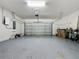Spacious two-car garage with epoxy floor, overhead door, and ample space for storage at 6514 Barnstorm Way, St Cloud, FL 34771