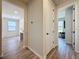 Hallway view of office with pink accents, and bedroom with workout equipment at 6514 Barnstorm Way, St Cloud, FL 34771