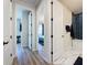 Hallway view of bathroom with modern blue-tiled shower and bedroom with blue-green accents at 6514 Barnstorm Way, St Cloud, FL 34771