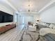Bright living room features wood floors, recessed lighting, and a comfortable sectional sofa with decorative pillows at 6514 Barnstorm Way, St Cloud, FL 34771