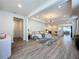 Open-concept living area featuring modern decor, stylish furniture and seamless flow to the kitchen at 6514 Barnstorm Way, St Cloud, FL 34771