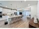 Open-concept living space featuring a kitchen with island seating and a living room with modern decor at 6514 Barnstorm Way, St Cloud, FL 34771